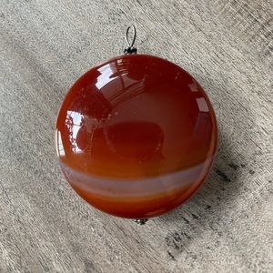- Polished banded round Carnelian agate pendant